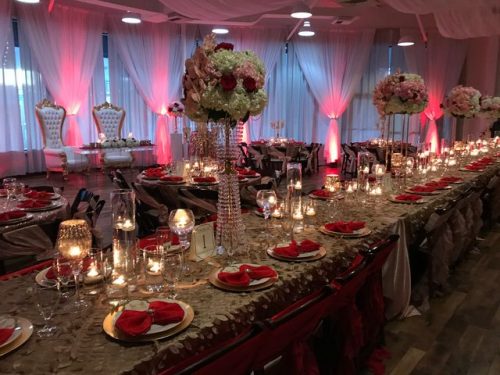 Gorgeous red and gold table settings, throne-like white wedding chairs