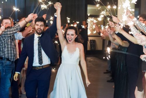 Man and woman who just got married holding hands and running through a sparkler arch, 660 LaFayette Street, Horton Group Downtown Nashville