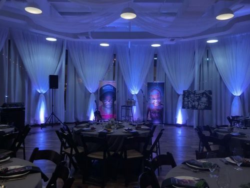 Project R12 event room glowing blue with round tables, 660 LaFayette Street, Horton Events Downtown Nashville