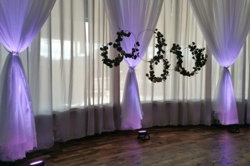 Full length windows with white sheers and a purple light casting from the floor, 600 LaFayette Street, Horton Events Downtown Nashville
