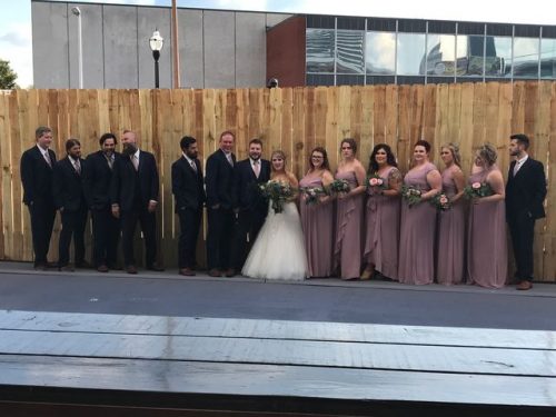 Bridal party standing in front of the fence at 660 LaFayette Street Horton Events Downtown Nashville