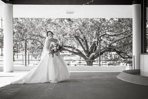 Beautiful smiling bride holding a bridal bouquet on the patio at 660 LaFayette - Horton Events Downtown Nashville