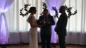 Couple saying their vows with pretty purple and white drapes in the background. Horton Events Downtown Nashville Couple saying their vows with pretty purple and white drapes in the background. Horton Events Downtown Nashville