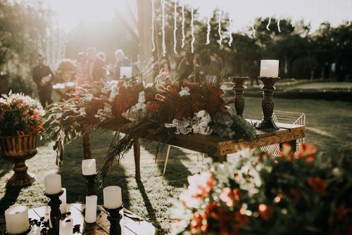 Outdoor wedding table with wildflowers and ornate candlesticks with white candles. Save Money On Your Wedding - Horton Events Nashville