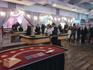 BMG-BR Nashville holiday party at Horton Events Downtown with a crowd of people talking at casino tables, people talking