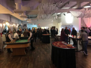 BMG-BR Nashville holiday party at Horton Events Downtown with a crowd of people talking at casino tables