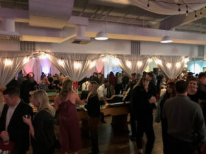 BMG-BR Nashville holiday party at Horton Events Downtown with a crowd of people talking and playing casino games
