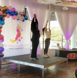 Two ladies on a stage stretching, Ladies Lifestyle Affair - Horton Events Downtown Nashville