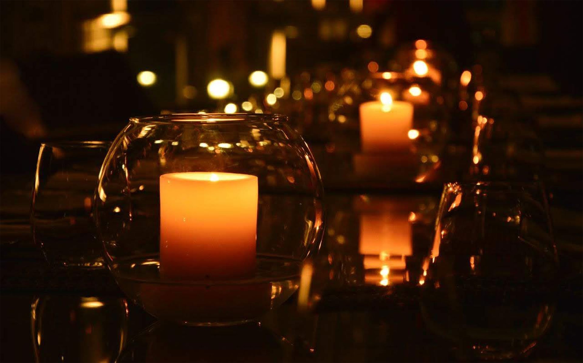 Candles in small glass holders on a long dinner table - Planning A Mystery Murder Dinner Event, Horton Events