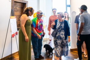 Whiskey Wine and Whiskers 2024 (20) guests walking in front of venue entrance to an event