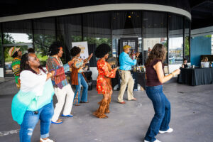 Groovy people dancing in the outdoor covered patio