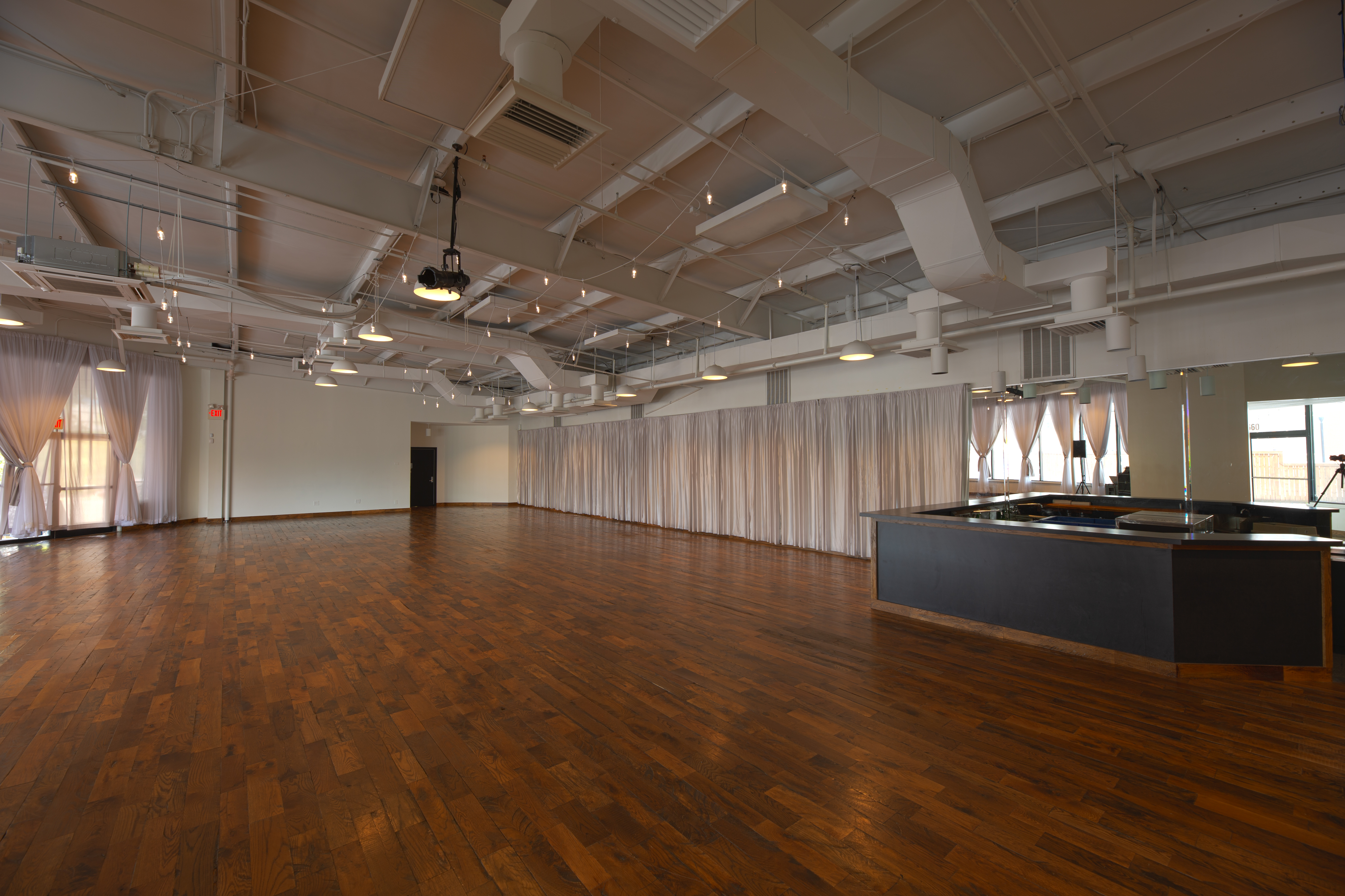 photo of the Main Showroom from the entryway, including the interior bar in relation to the rest of the space