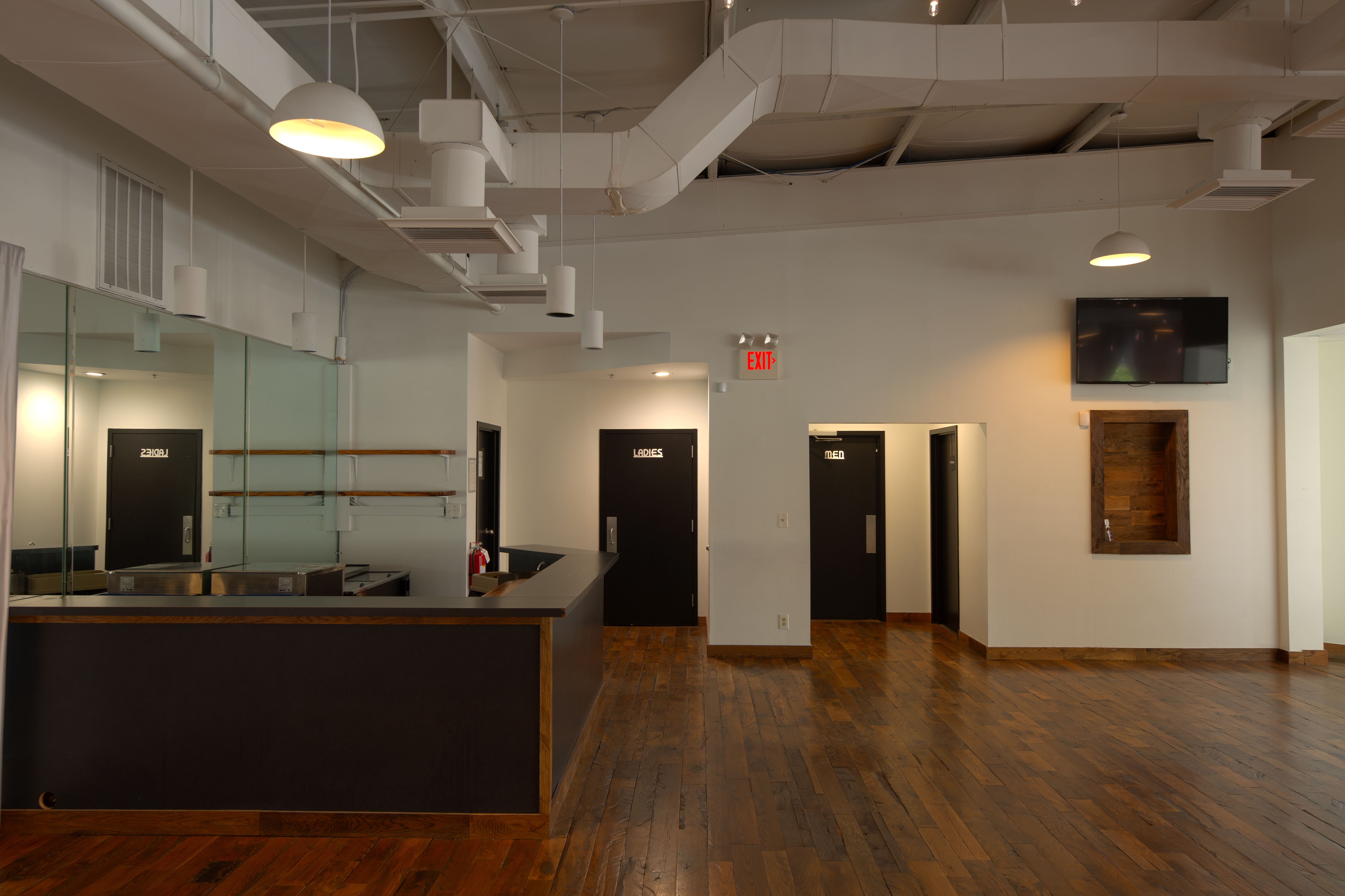 photo of the Main Showroom, including bar, entryway, & men's & women's restrooms