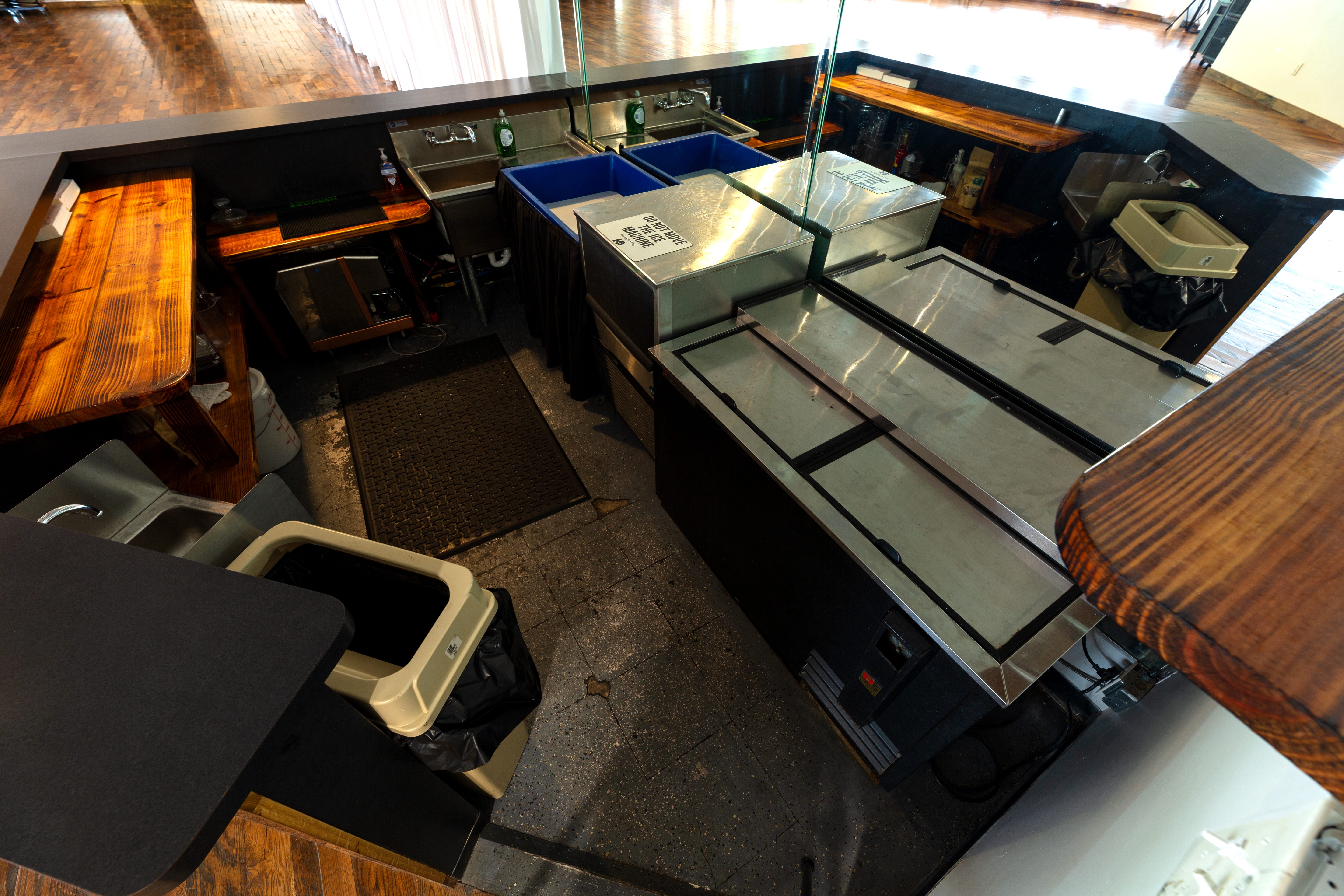 Photo showing the back of the bar area, including ice machine, cooler, sinks, ice chest & prep areas