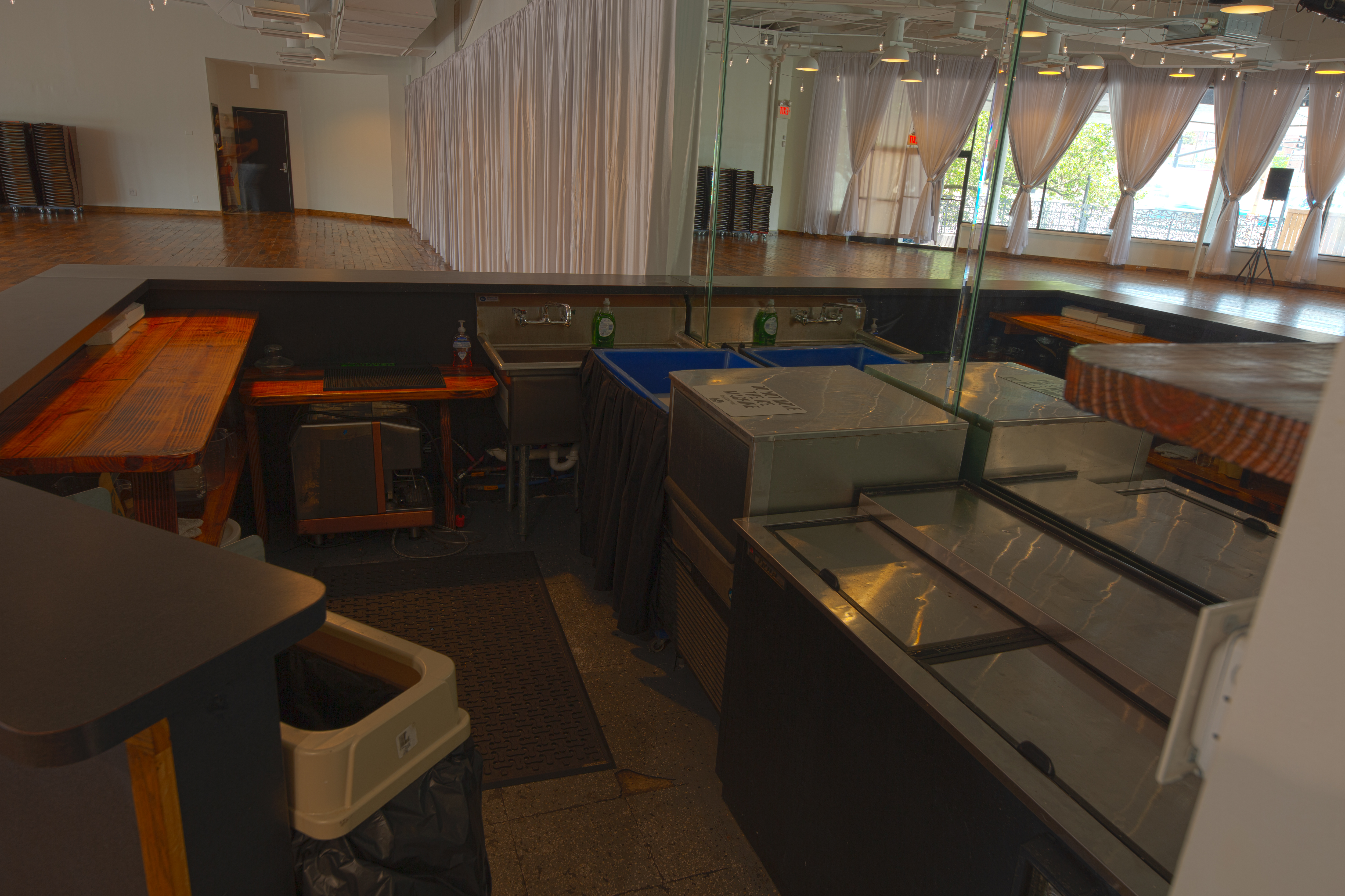 Photo showing the back of the bar area, including ice machine, cooler, sinks, ice chest & prep areas